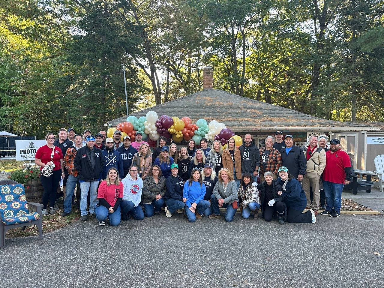 Festival-goers gathered near a fall display and truck