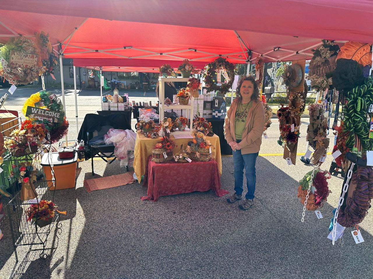 A vendor booth of handmade fall wreaths and autumn decor