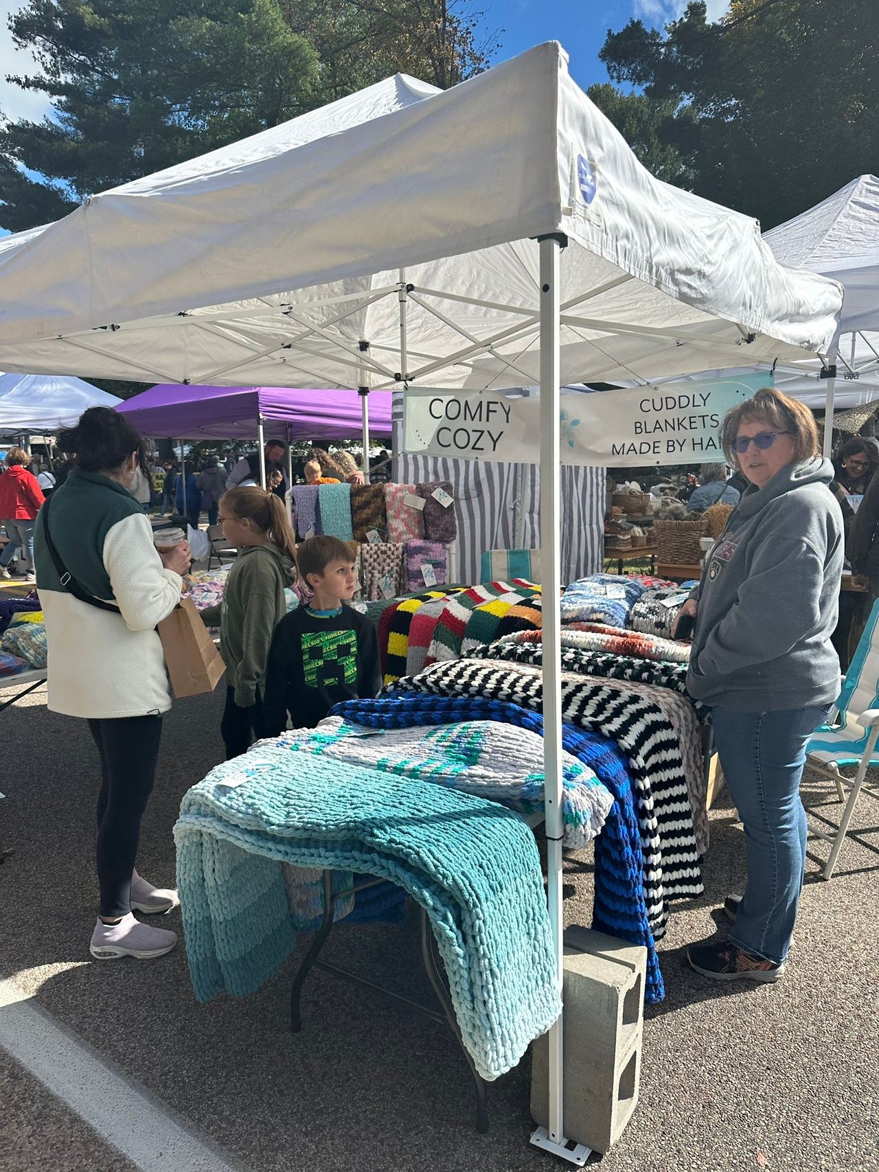 Vendor tents lining the strip with fall flowers